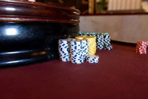 Poker Chips on a gaming table with dramatic lighting Stock Photos