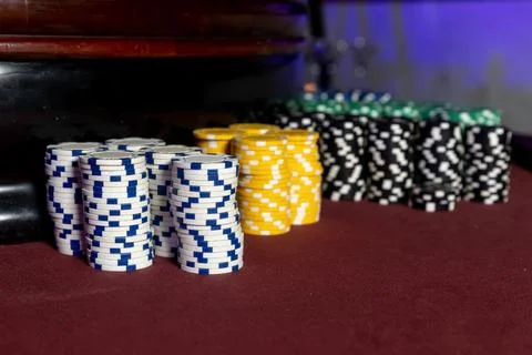 Poker Chips on a gaming table with dramatic lighting Stock Photos