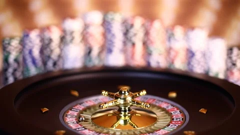 Poker Chips on gaming table, roulette wheel in motion Stock Footage 97502469
