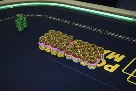 Poker chips placed on a table before beginning the game Stock Photos