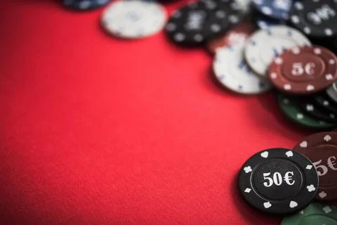 Poker chips on a red table Stock Photos