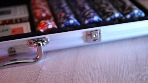 Poker chips slowly fall onto the table next to the chip box. 4к Stock Footage 124132907