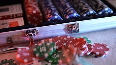 Poker chips slowly fall onto the table next to the chip box. 4к Stock Footage 124133044