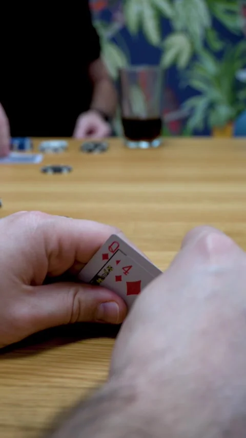 Poker dealer distributing cards while player checks hand Vídeo Stock 335706533