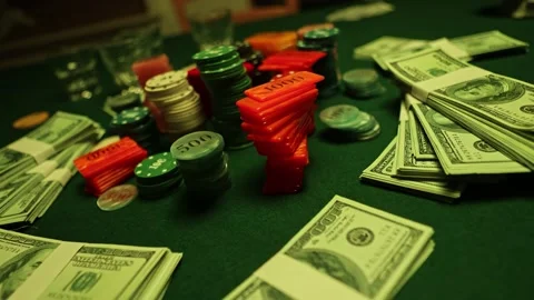 Poker night with stack of chips dollars whiskey glasses and cigar smoke in ro Stock Footage 230235547