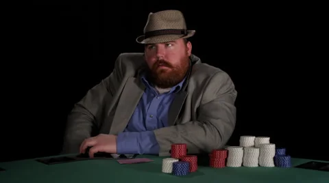 Poker player appears agitated as he awaits his turn to make a bet Stock Footage 53235503