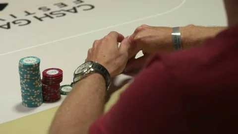 Poker Player checking cards Stockbeeldmateriaal 82930563