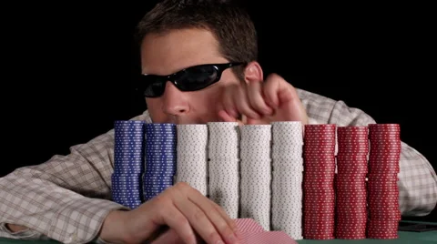 Poker player counts his large stacks of chips that partially hide him Stock Footage 53244841