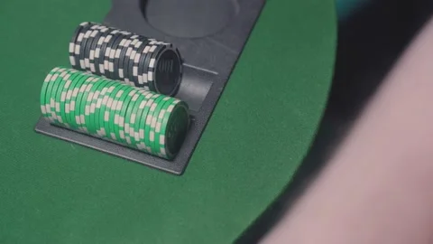 Poker player doesn't legally pull a card from under the table. Cheater doesn't Stock Footage 221873722