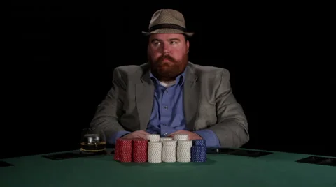 Poker player looks at his cards and then pushes all his chips all in Stock Footage
