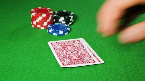 Poker player with pocket 2 and 7 looks at his cards. Stock Footage 58743082