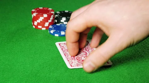 Poker player with pocket pair of aces looks at his cards. Stock Footage 58741650