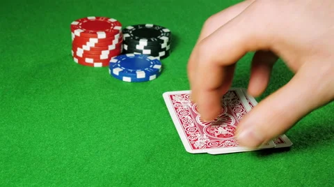 Poker player with pocket pair of aces looks at his cards. Stock Footage 58741708
