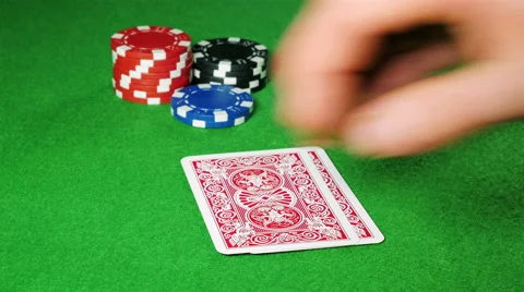 Poker player with pocket pair of queens looks at his cards. Stock Footage 58742230