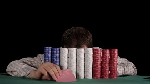 Poker player pops up from behind his large stacks of chips and laughs crazily Stock Footage 53236165