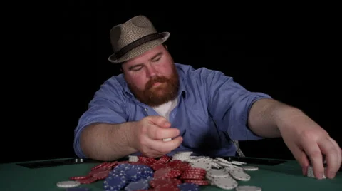 Poker player stacks chips from a pot he just won Stock Footage 53245116