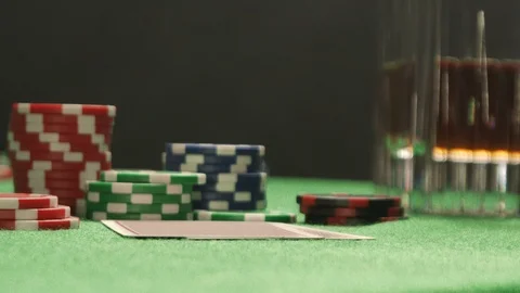 Poker player with a tattoo checking his hand, having a pair of jacks. Stock Footage 126007123