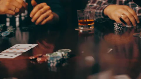 Poker player throws cards on table, on gaming table glasses of whiskey, chips. Stock Footage 161603965