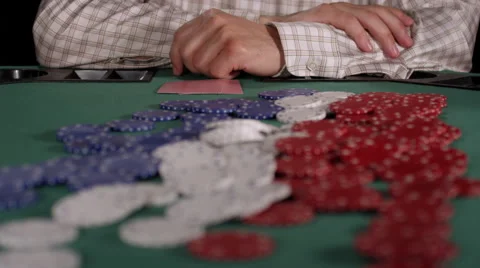 Poker player throws down an ace and jack on the pot and then drags it toward him Stock Footage 53242108