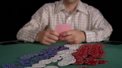 Poker player throws down an ace and jack on the pot and then dragsit towards him Stock Footage 53245235