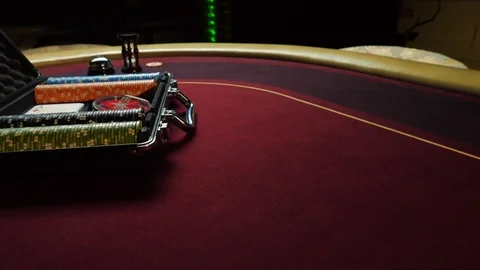 Poker table with poker chips in suitcase and falling on the table in casino Vídeo Stock 104483058