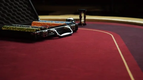 Poker table with poker chips in suitcase and falling on the table in casino Stock Footage 104861200
