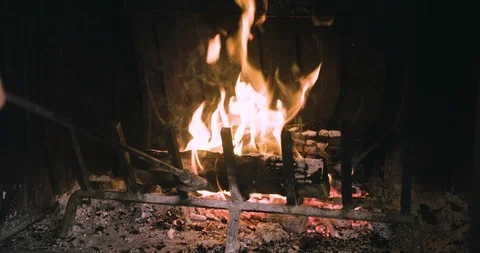 Poking a fire burning In a fireplace Stockbeeldmateriaal 97872701