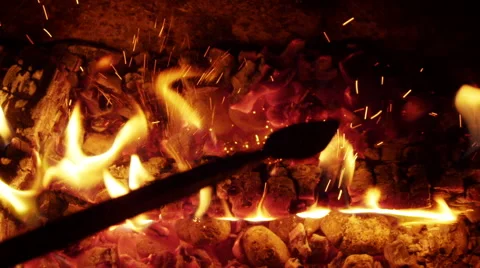 Poking the fireplace in the evening Stock Footage 42254899