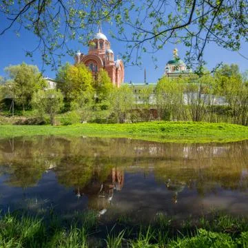 Pokrovsky Intercession Khotkov monastery in spring is reflected in the water. Stock Photos