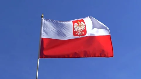 The Poland flag with eagle waving in the wind in the blue sky Stock Footage 282432911