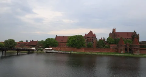 Poland Malbork Castle across river to building pan 4K Stock Footage 334979605