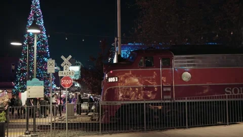 Polar express train engine in front of Christmas tree Stock Footage 293947656