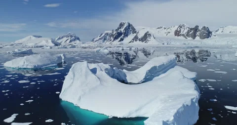 Polar seascape with iceberg at ocean bay aerial. Snow covered mountain at coast Stock Footage 148356682