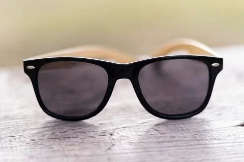 Polarized glasses on a wall with a blurred background. brand of sunglasses an Stock Photos