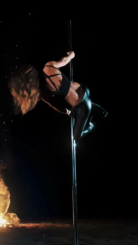 Pole dance. witch halloween. fit female gymnast, in black leather outfit and Video stock 315944465