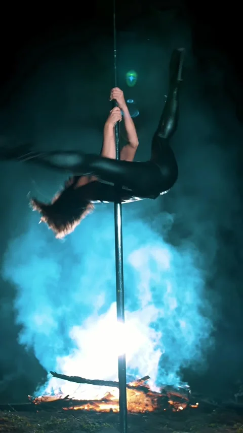 Pole dance. witch halloween. fit female gymnast, in black leather outfit and Video stock 318145656