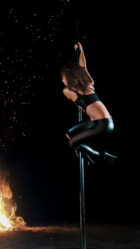 Pole dance. witch halloween. fit female gymnast, in black leather outfit and Video stock 318244014