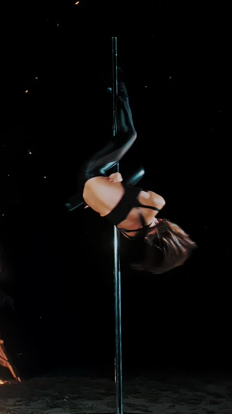 Pole dance. witch halloween. fit female gymnast, in black leather outfit and Stock Footage 318684347