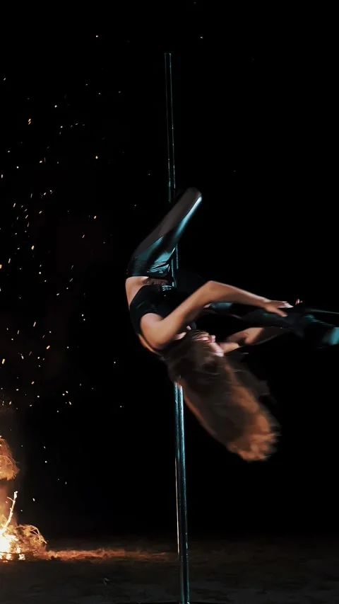 Pole dance. witch halloween. fit female gymnast, in black leather outfit and Video stock 318806845