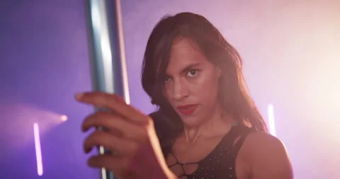 Pole dancing, face and neon with woman in club for exotic performance, light and Stock Footage 306238052
