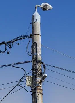 A pole full of cables under the blue sky Stock Photos