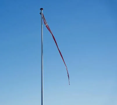 Pole with long Denmark flag streamer ribbon blowing in wind. Stock Photos