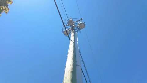 Pole mounted electrical transformers on power line grid system Stock Footage 340155346