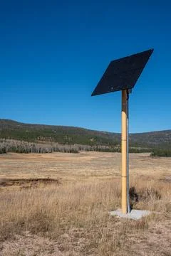 Pole with a solar panel on top of it Stock Photos