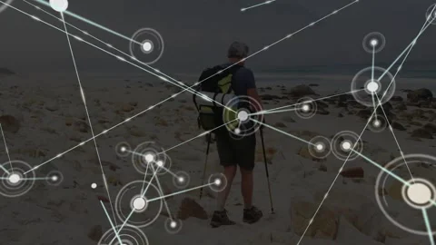 Pole-using hiker advancing along rocky beach starting tech node network mapping 스톡 동영상 317741463