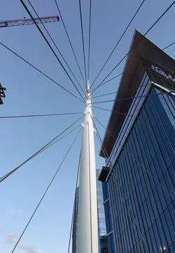 Pole With Wires From All Angles With Building And Clear Blue Sky Stock Photos