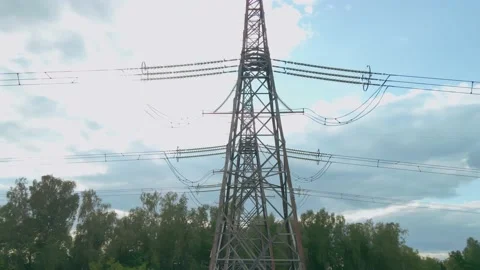Poles supporting high voltage overhead power line. On the pylon are wires that Stock Footage 158182832