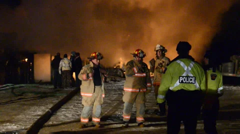 Police and Firefighters with fire and flames in back ground in winter Stock Footage 36630341