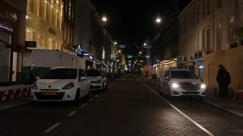Police and security guards during night curfew. Amsterdam, Netherlands. Stock Footage 147944284