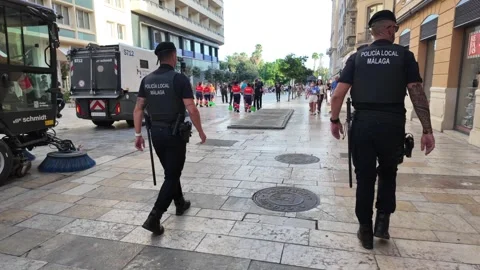 Police and Street Cleaning Services in Malaga City Center Stock Footage 345666331